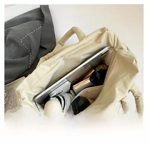 Top view of beige quilted handbag interior showing spacious capacity for daily essentials