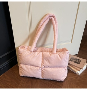 Close-up of a light pink quilted puffer tote bag with spacious interior for daily use