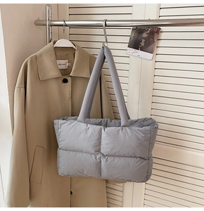 Detail of grey quilted puffer tote bag with rectangle stitching and large capacity