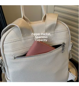 Detail of lychee pattern leather backpack with back zipper anti-theft pocket showing a wallet