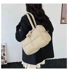 Detailed view of beige quilted tote bag showing its soft texture and large capacity