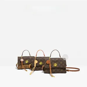 Detail of vintage patterned crossbody bags with gold locks and leather fringe tassels