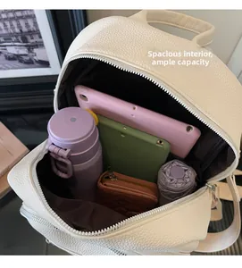 Internal view of a white textured leather backpack showing spacious large capacity storage