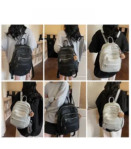 Detailed views of stylish faux leather backpacks in black and beige with plush ball charms