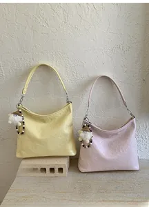 Detail of artistic pleated texture on yellow and pink PU leather shoulder bags with charms