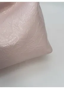 Close-up of pink wrinkled texture fabric and soft glossy finish on a tote bag