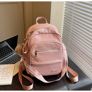 Pink PU leather backpack featuring lychee texture and a cute decorative fur ball charm