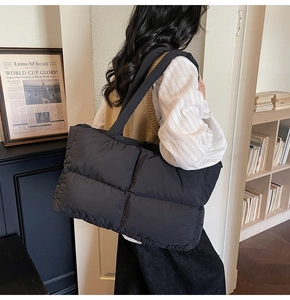 Detail of black quilted puffer tote bag showing large capacity and stylish texture