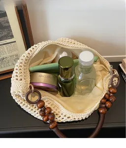 Close-up of beige crochet tote bag with wooden bead handle and spacious interior