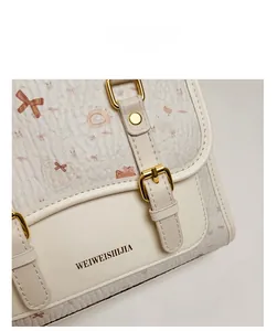 Close-up of litchi pattern faux leather with cute cartoon prints and gold hardware