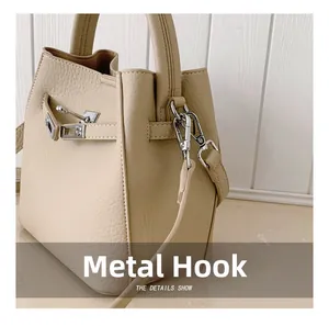 Detailed close-up of premium cream leather bucket bag featuring silver metal hardware