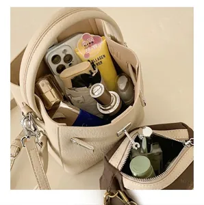 Top view of beige bucket bag showing interior storage capacity for daily essentials
