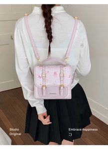 Detail of light purple PU leather mini backpack featuring cute cat and cupcake prints