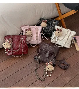 Detailed display of quilted bucket bags in five colors with cute bear charms and chains