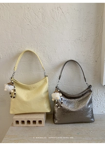 Chic wrinkled leather underarm bags in cream yellow and silver with plush charms