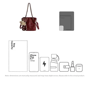 Detail showing deep red quilted chain bag capacity and compatibility with various gadgets