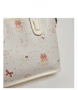 Close-up of litchi texture faux leather on tote bag with cute cartoon cat and cake prints