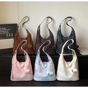 Multiple hobo tote bags in six colors with geometric texture and matching charms