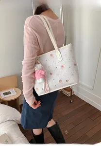 Large white tote bag featuring cute cartoon prints and a plush bear pendant charm