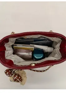 Detailed top view of red quilted bucket bag interior showing spacious storage space