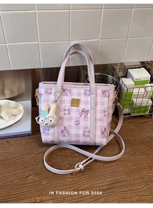 Detail of lavender plaid bucket bag with cartoon patterns and cute white rabbit plush charm