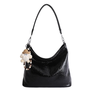 Glossy black pleated hobo shoulder bag with a cute plush doll charm and beaded strap