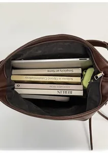 Interior view of large capacity dark brown tote bag showing spacious room for a laptop and books
