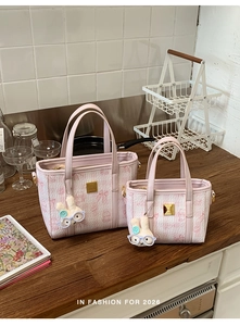 Detail of pink bucket bag set with cute rabbit charms and embossed patterns for 2026