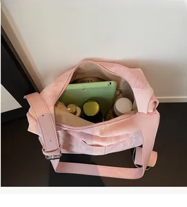 Top view of pink textured crossbody bag showing spacious interior and large capacity