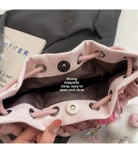 Detail of pink leather bucket bag interior with a strong magnetic buckle closure