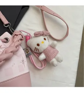 Close-up of Hello Kitty plush charm in pink dress on a stylish bucket bag accessory
