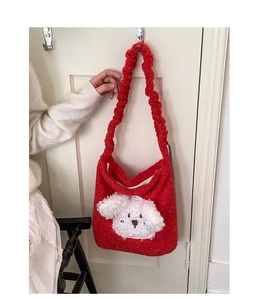 Detail of red plush bucket bag with cute white puppy patch and ruffled shoulder strap