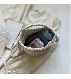 Top view of cream woven bucket bag showing large capacity with umbrella and phone inside