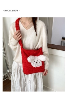 Detail of red plush bucket bag featuring a cute white puppy patch and soft teddy fleece