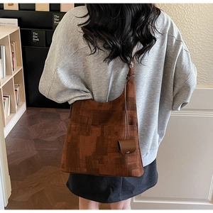 Detail of dark brown geometric print canvas hobo bag with matching leather mini pouch