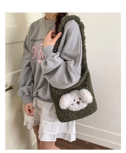 Detail of green plush puppy bucket bag shown on model for size and style reference