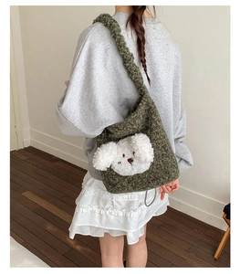 Detail of cute plush dog bucket bag in dark green knit fabric with soft texture