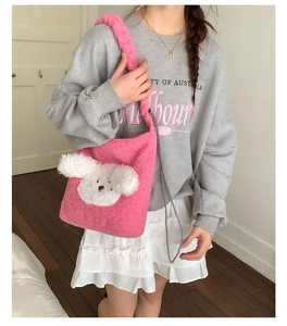 Pink plush bucket bag with a 3D puppy design shown on model for size perspective
