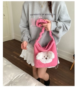Pink plush puppy bucket bag detail with white dog face and metal chain strap