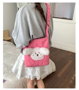 Pink plush puppy bucket bag detail showing soft lamb wool texture and crossbody strap