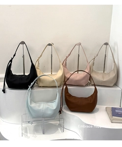 Detailed display of crescent hobo bags in multiple colors on a geometric display stand