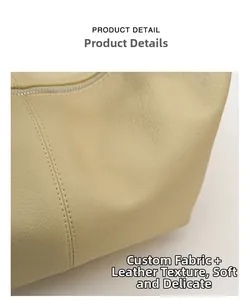 Close-up of soft lychee-patterned leather texture and neat stitching on beige bag