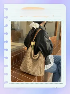 Detail of hand-woven straw tote bag with brown leather strap and hollow grid texture