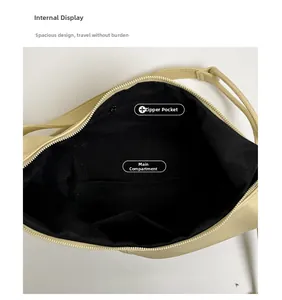 Detailed view of beige shoulder bag interior showing black lining and zip pocket