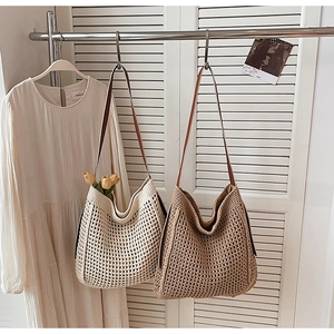 Detail view of woven shoulder bags in beige and brown with premium leather straps
