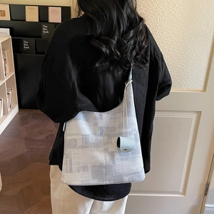 Minimalist light blue hobo shoulder bag with abstract geometric patterns and mini pouch