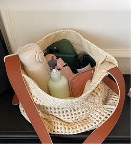 Detail of woven mesh bag interior showing large capacity for umbrella and daily items