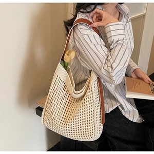 Detail of hand-woven crochet tote bag with brown leather straps and tulip decor