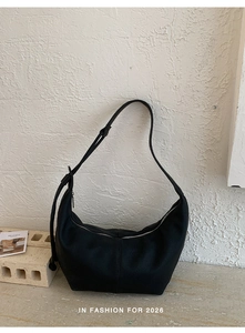 Close-up of black lychee texture hobo bag showing soft leather and silver zipper detail