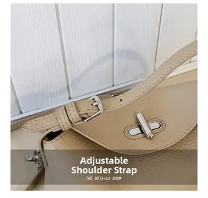 Close-up of litchi texture beige bag showing silver twist lock and adjustable buckle strap